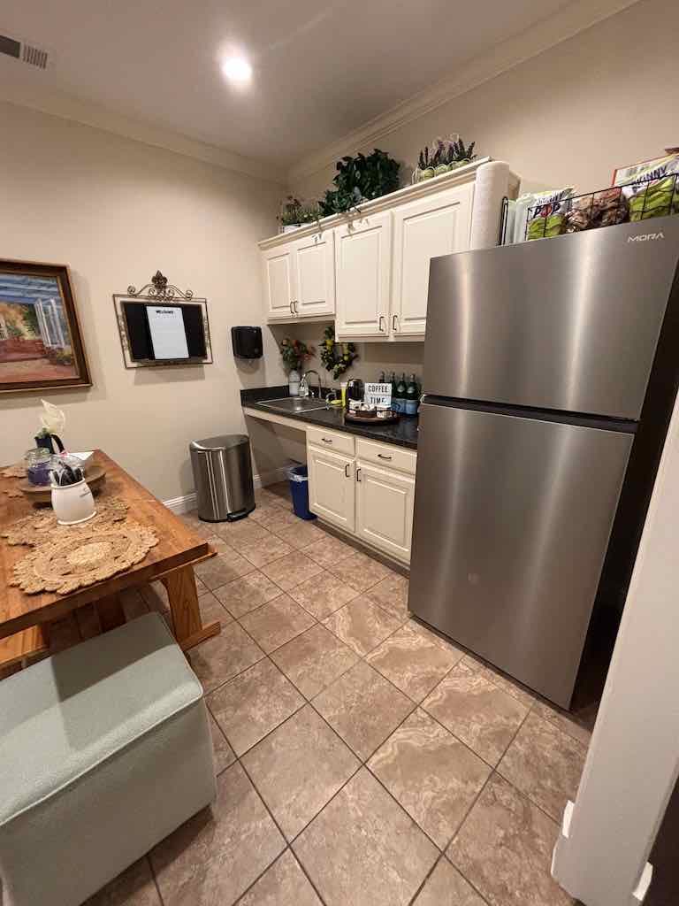 Shared kitchen and lounge with coffee station and full-size fridge